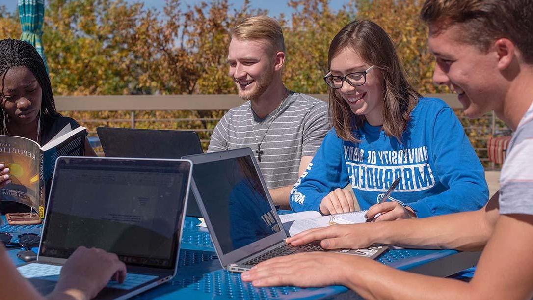 Students studying outside on a fall day